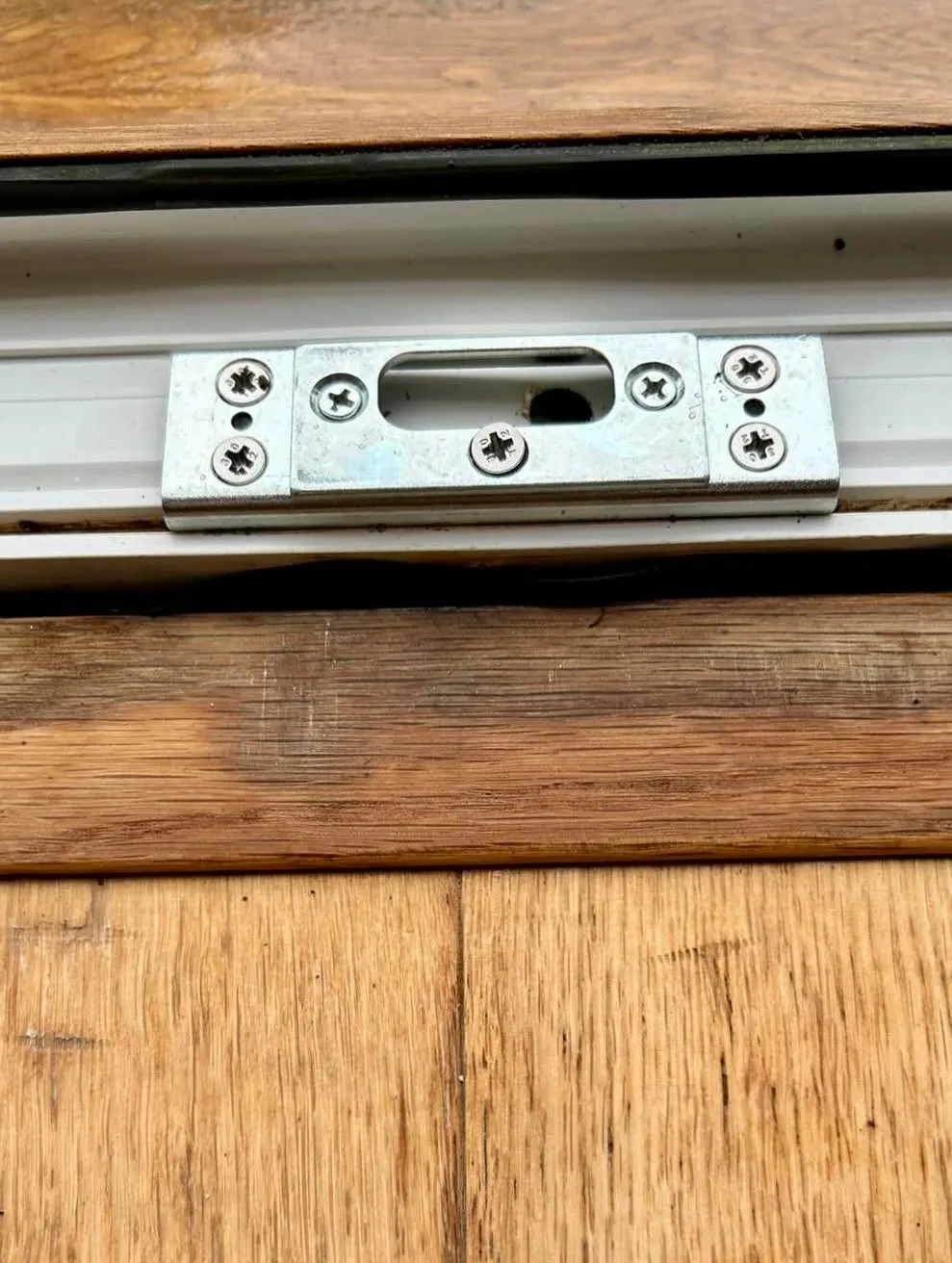 A new lock keep plate fitted to a timber door frame